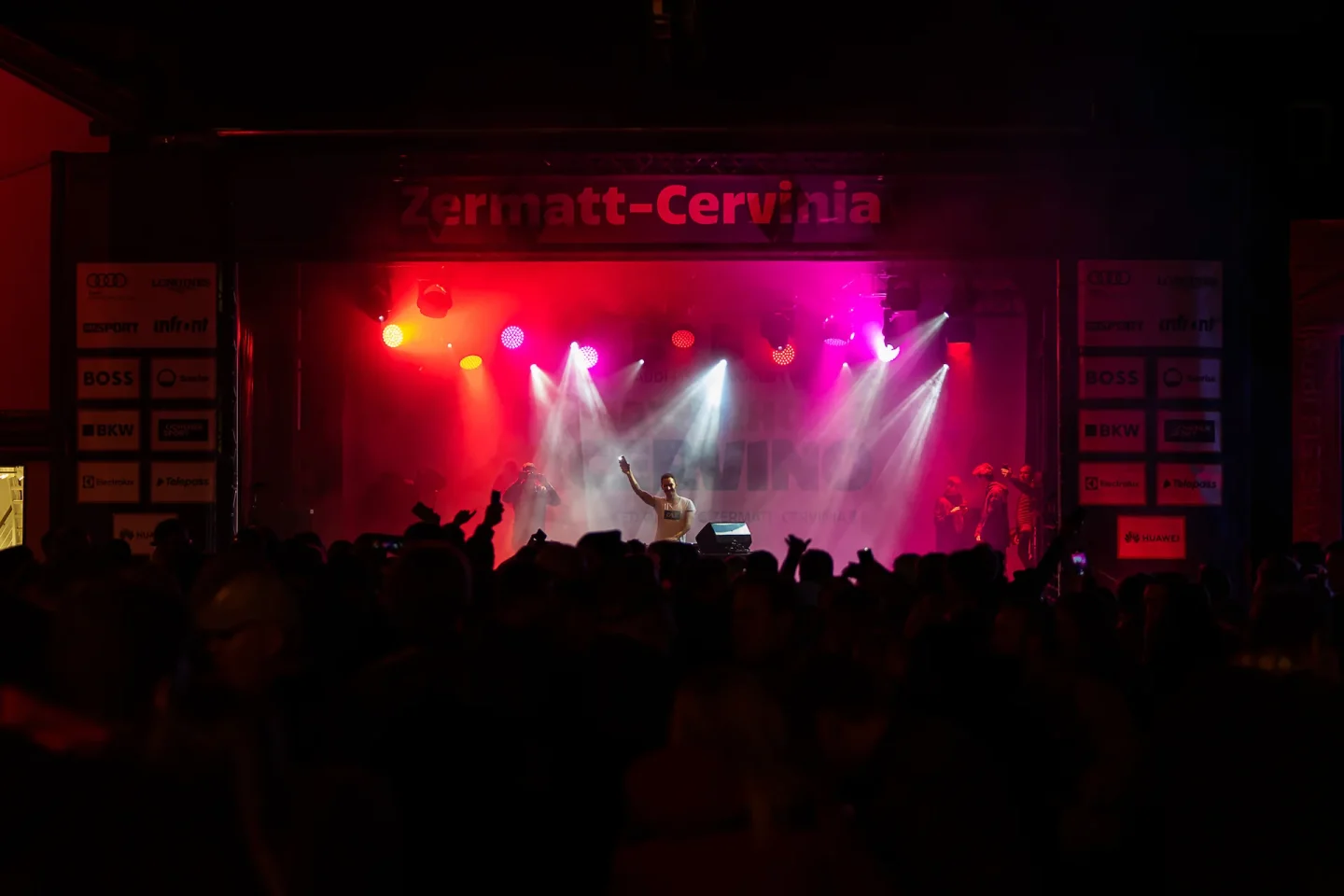 Cale am DJ-Pult auf der beleuchteten Weltcup-Bühne in Zermatt vor Publikum
